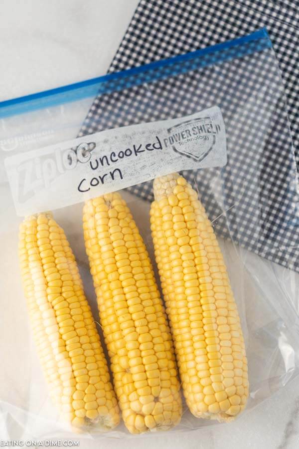 Photo of 3 ears of uncooked corn in a freezer bag.