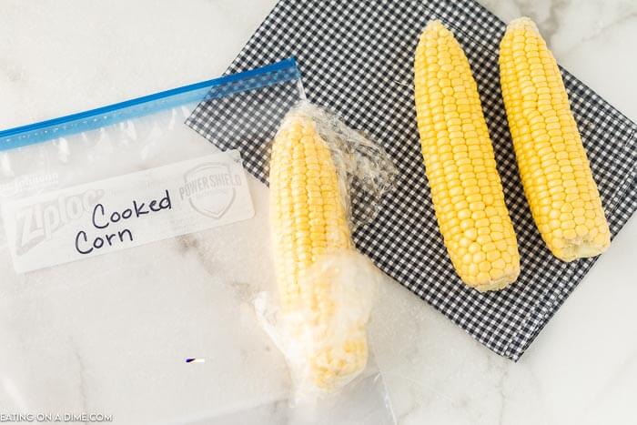 Picture of cooked corn on the cob wrapped and ready to be frozen.
