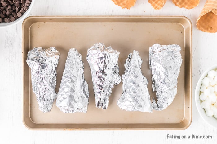 Foil wrapped cones on a baking sheet