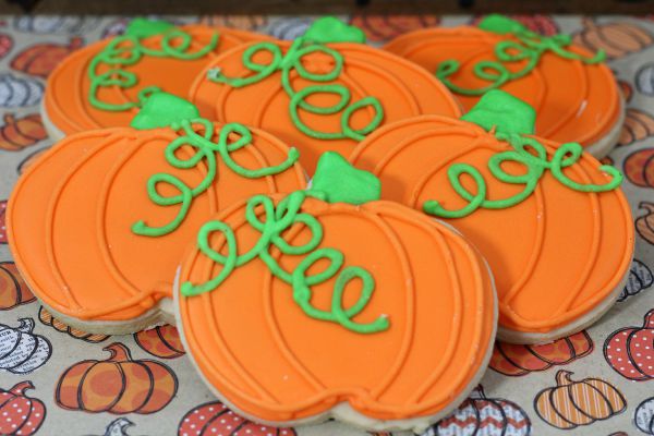 Close up image of decorated pumpkin shaped cookies. 