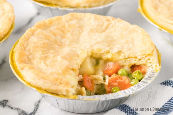 Copycat KFC Chicken Pot Pie is a fun and tasty dinner idea. These are fun mini chicken pot pies that you can easily reheat for a quick meal.#eatingonadime #copycatrecipes #chickenpotpies #kfcchickenpotpie #easydinnerrecipes 