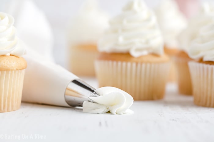 Once you learn how to make buttercream icing you'll never buy store-bought icing ever again! Fluffy and perfect vanilla buttercream frosting every time! This will be your favorite easy vanilla buttercream frosting recipe. Learn how to make the best buttercream frosting recipe easy! #eatingonadime #frostingrecipes #icingrecipes