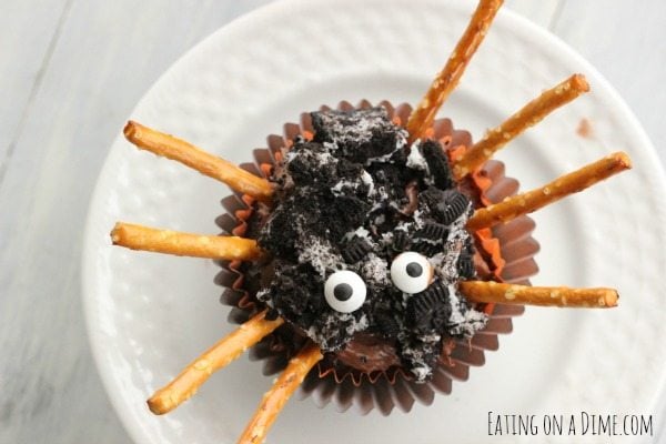This Easy Spider Cupcake recipe is great for Halloween for kids. The entire family will love making these easy spider cupcakes made with a chocolate cake mix, Oreos and with pretzel legs for decorations. Learn how to make these Simple DIY Halloween Oreo cupcakes with pretzels. These cupcakes are not spooky or scary but are the perfect Itsy Bitsy Cute Halloween treat! #eatingonadime #halloweendesserts #halloweencupcakes #spidercupcakes