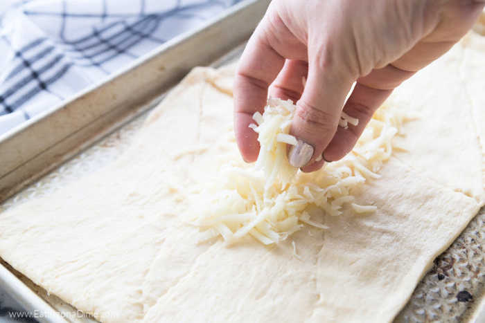 Topping the bread dough the cheese