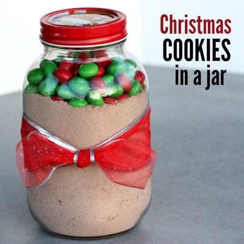 Make this Christmas cookies in a jar recipe for a homemade gift idea. Everyone will love this m&m cookie in a jar recipe that is an adorable decoration as well. It is quick and easy to make this DIY jar recipe to give as a gift so that they can make baked cookies in no time at all. #eatingonadime #jarrecipes #christmascookies 