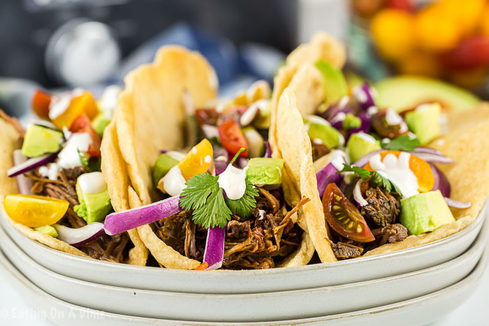 Enjoy Crock pot shredded beef tacos loaded with tender beef. The slow cooker does all of the work and all you need to do is add your favorite toppings! 