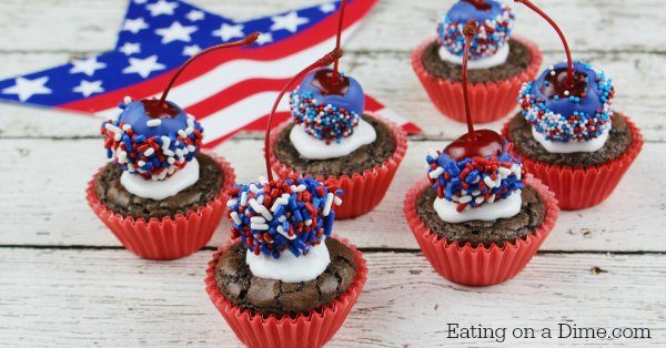 Six 4th of July Bomb Brownie Bites on a wooden board with a star in the back ground. 
