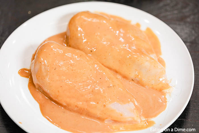 Chicken breast on a plate with marinade