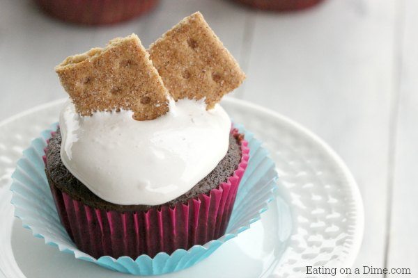 This delicious Smores cupcake recipe will satisfy all of your cravings for ooey gooey smores. Each bite is decadent and the perfect dessert.