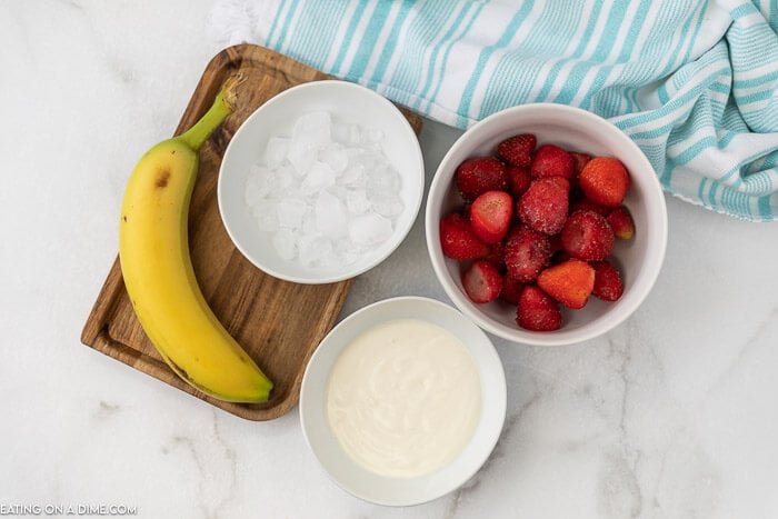 Ingredients needed to make a smoothie: Bananas, strawberries, greek yogurt and ice 