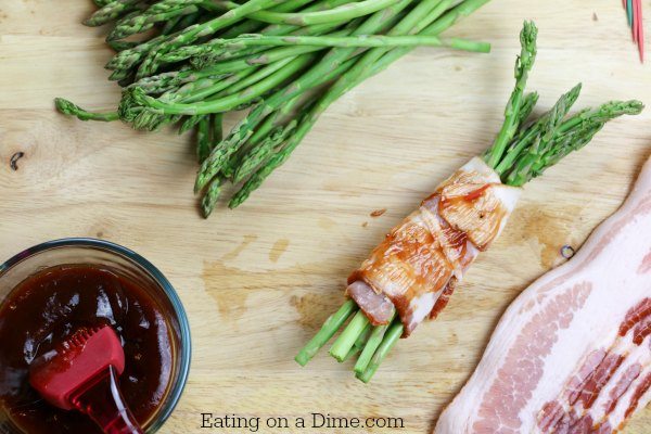 Wrapping the asparagus with bacon