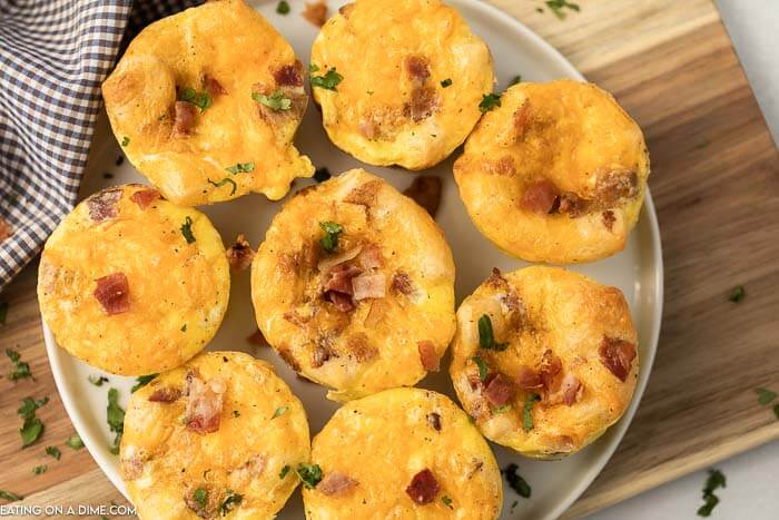 Easy Egg Muffins on a white plate on a wood platter 
