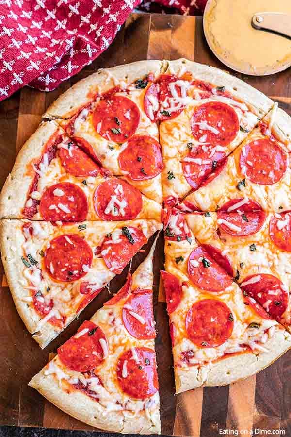 A pepperoni pizza cut into slices 