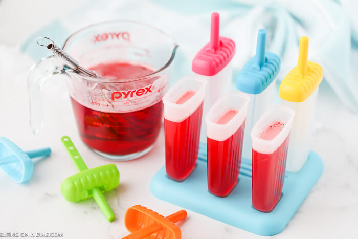 pouring liquid in the popsicle molds