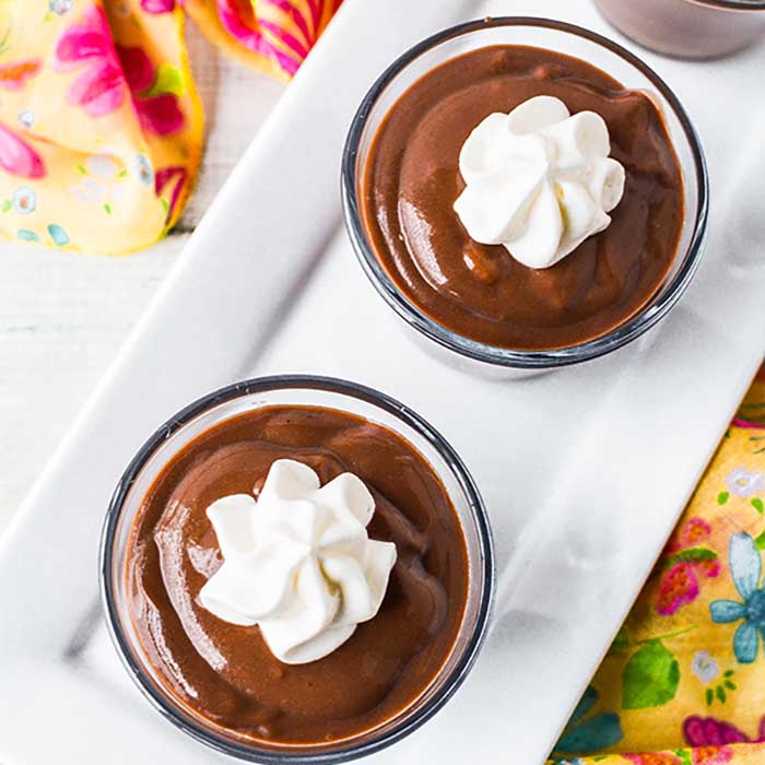 Chocolate Pudding in glasses and topped with whipped cream