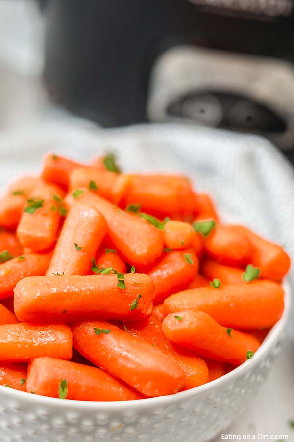 Close up of glazed carrots topped with parsley 