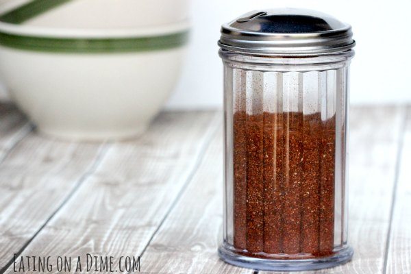 Close up image of homemade chili seasoning in a glass jar. 