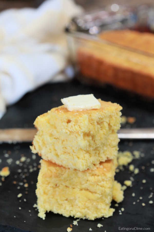 Close up image of cornbread with butter on top. 