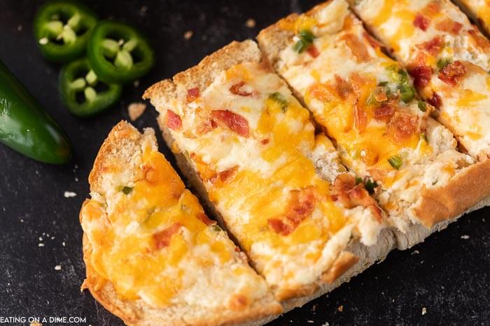 Jalapeno popper stuffed cheesy bread recipe is the perfect appetizer and also delicious with a meal. Each bite is so cheesy and delicious.