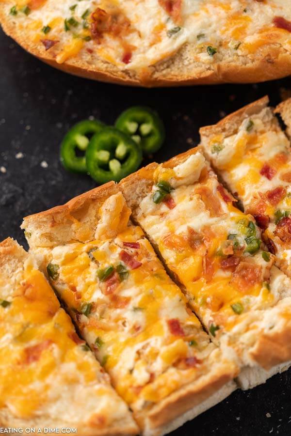 Jalapeno popper stuffed cheesy bread recipe is the perfect appetizer and also delicious with a meal. Each bite is so cheesy and delicious.