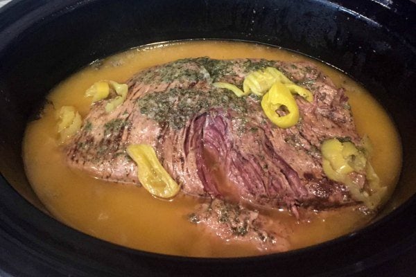 Cooked roast in the slow cooker with gravy