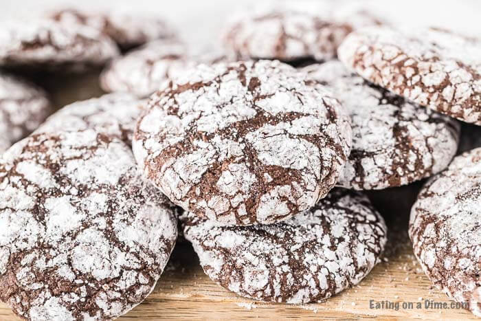 Try this easy Chocolate Brownie Cookies recipe. They are easy to make with brownie mix boxes. Learn how to make chocolate brownie mix cookies from a box. These cookies made from box mixes are fudgy, chewy and perfect for Christmas. These fudge brownies cookies can be made with only 5 ingredients and everyone loves them! #eatingonadime #cookierecipes #browniecookies #christmasdesserts #dessertrecipes Stack of brownie cookies.