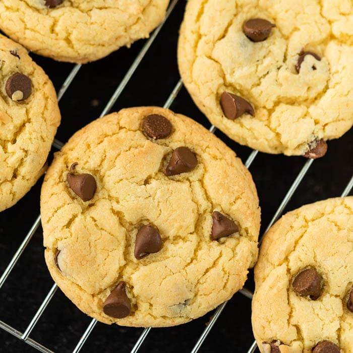 Chocolate chip cookies on a wire rack on a black countertop 