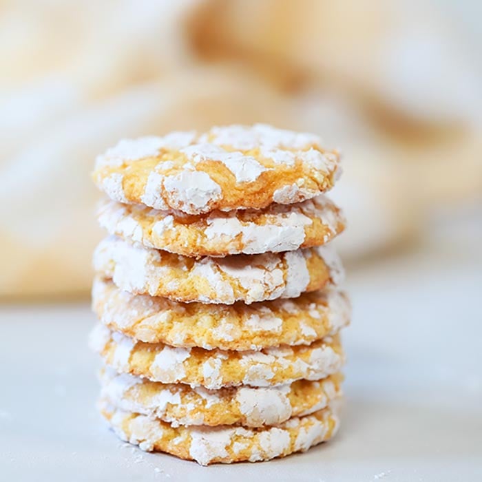 Close up of the lemon cool whip cookies stacked on top of each other.  