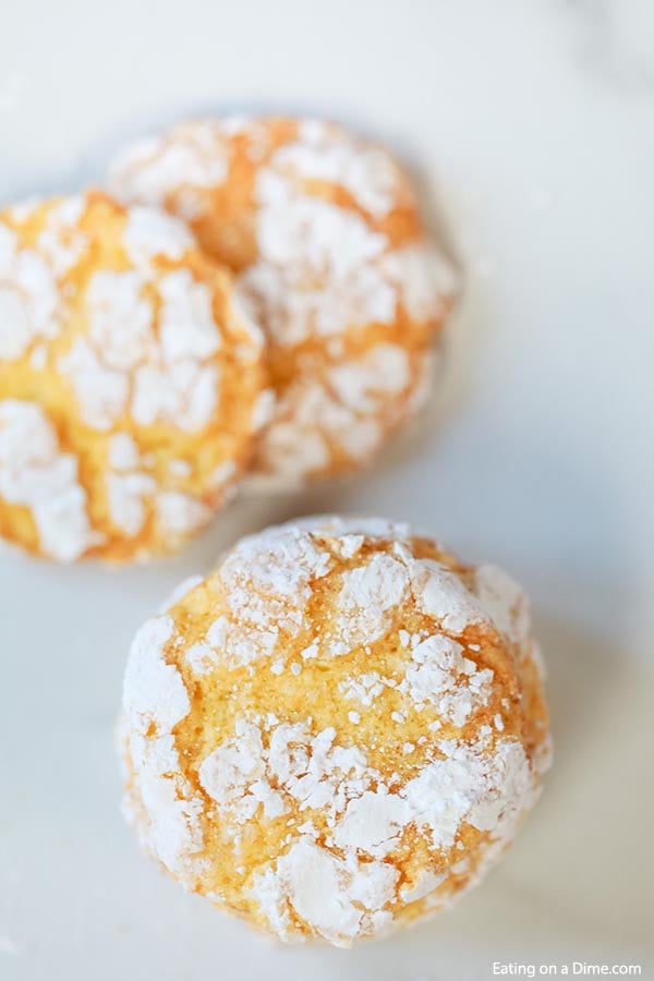 Close up of lemon crinkle cookies stacked on top of each other. 