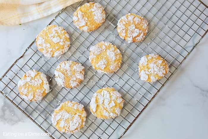 A close up of the cookies being placed on a cooling rack to cool completely. 