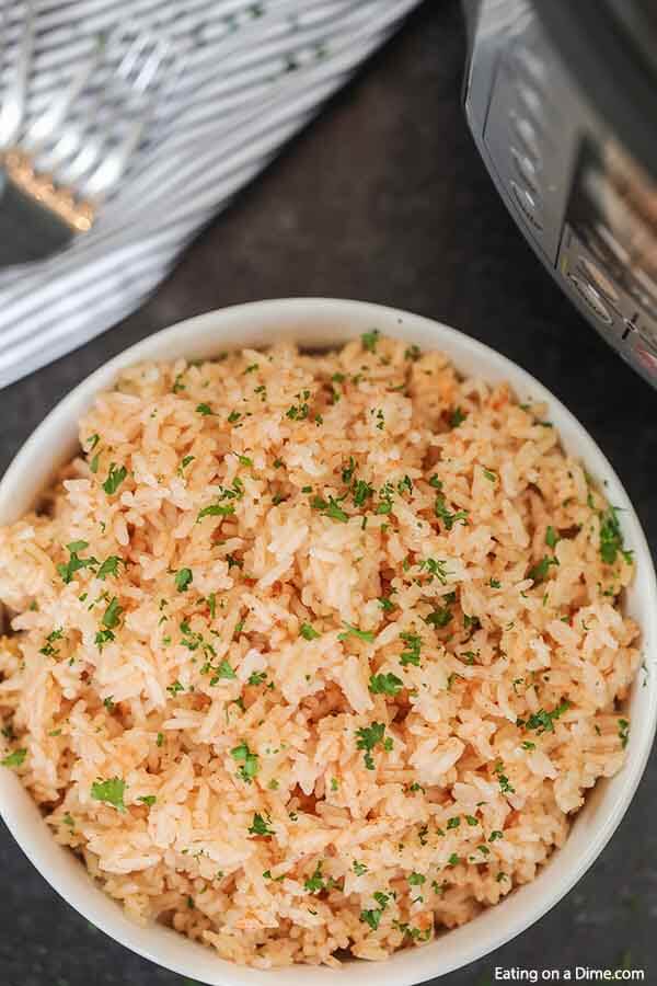  Instant Pot Spanish Rice recipe takes just minutes and makes the perfect side dish for enchiladas, tacos and more. The flavor is amazing!.#eatingonadime #instantpotrecipes #spanishrice #sidedishrecipe #easyrecipes 