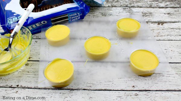 Melted candy melts poured on top of the Oreo Cookies in the molds 