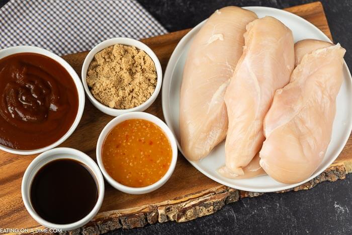 Ingredients to make crock pot bbq pulled chicken: chicken breasts, BBQ sauce, Italian dressing, brown sugar and Worcestershire sauce