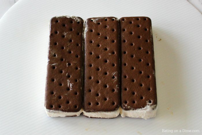 This is the best, Easy Ice cream Cake Recipe. This easy homemade ice cream sandwich recipe can be thrown together in no time making it the best ice cream cake recipe. You are going to love this DIY ice cream cake that is perfect for any occasion or birthday! #eatingonadime #icecreamcake #cakerecipes 