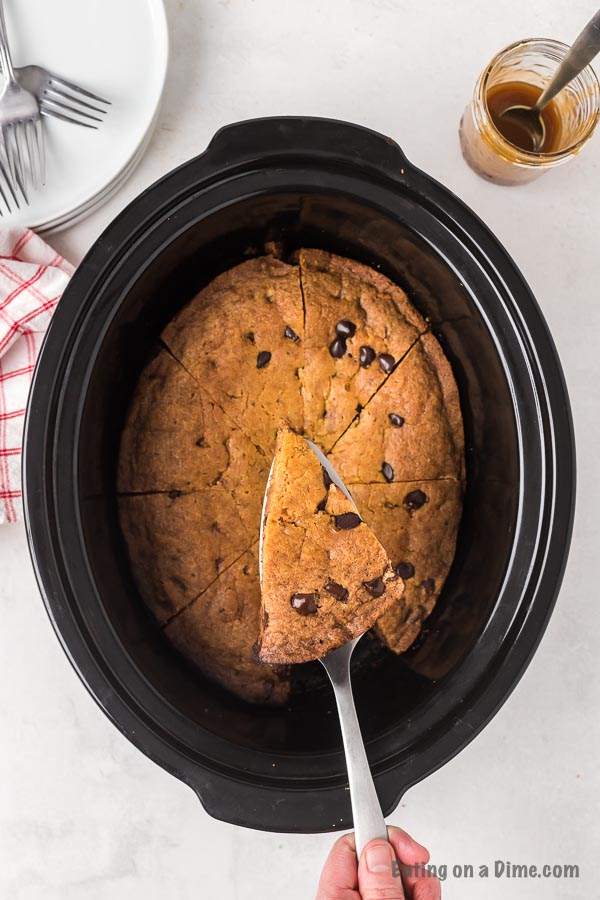 Crock pot chocolate chip cookie recipe is warm and gooey with lots of delicious chocolate. Serve this with ice cream for a real treat. 