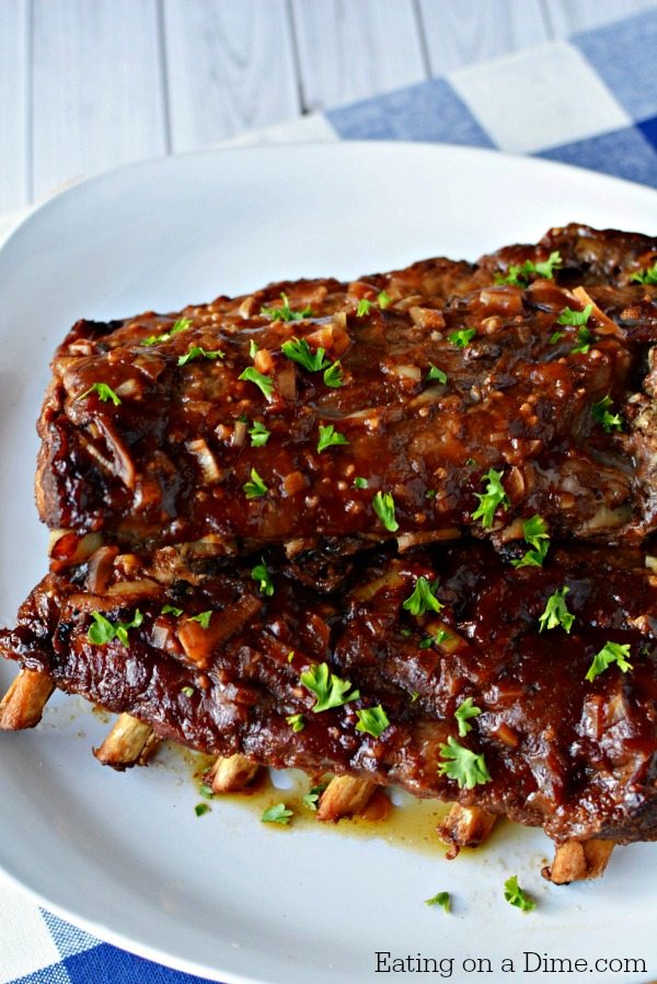 This slow cooker pork ribs recipe is easy to make and are fall off the bone tender! You'll never make ribs in the oven again once you make crock pot ribs! This is the best rib recipe ever! #eatingonadime #crockpotrecipes #dinnerrecipes 