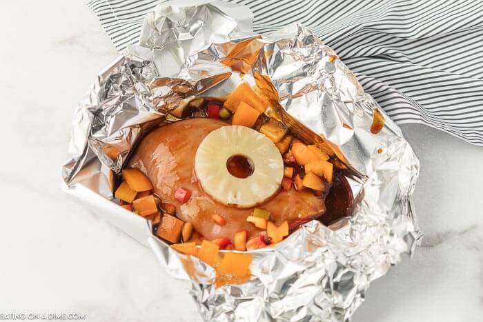Foil Packet Hawaiian BBQ Chicken Recipe is perfect for the grill, campfire, or oven.  Everyone will love the combination of sweet and tangy. 