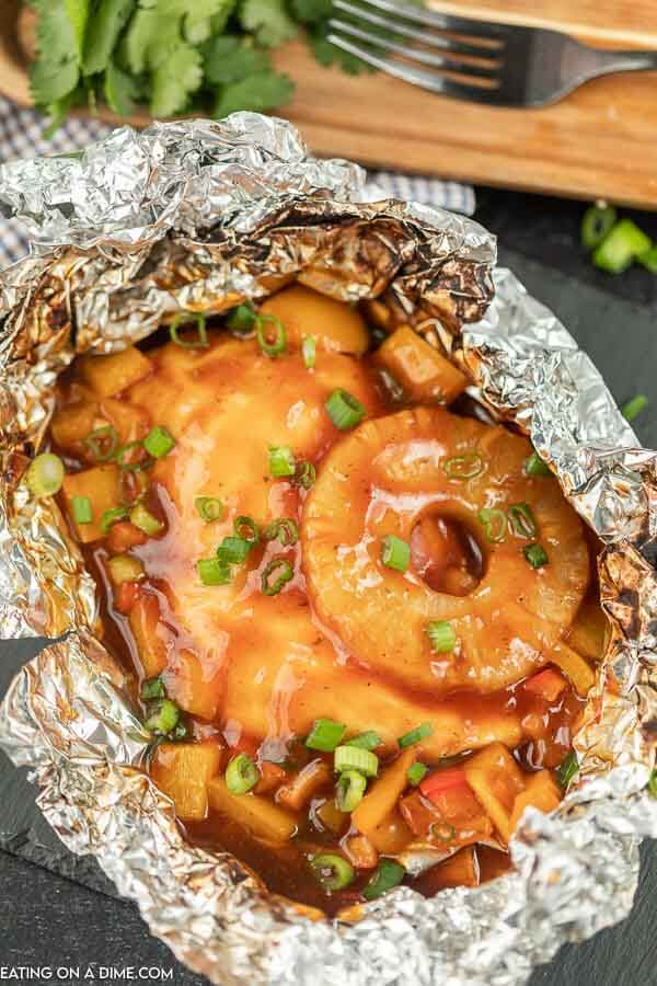 Foil Packet Hawaiian BBQ Chicken Recipe is perfect for the grill, campfire, or oven.  Everyone will love the combination of sweet and tangy. 