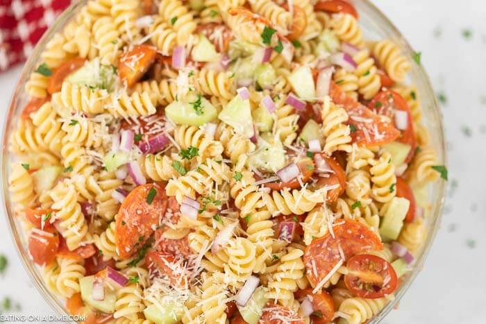 Easy pasta salad is perfect to feed a crowd on a budget. It's full of fresh ingredients and delicious pasta for a great side dish option. 