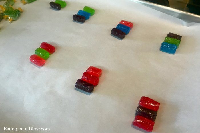 jolly ranchers laying next to each other (not melted) on a baking sheet lined with parchment paper 