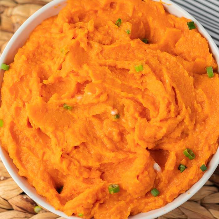 Closeup picture of mashed sweet potatoes in bowl. 