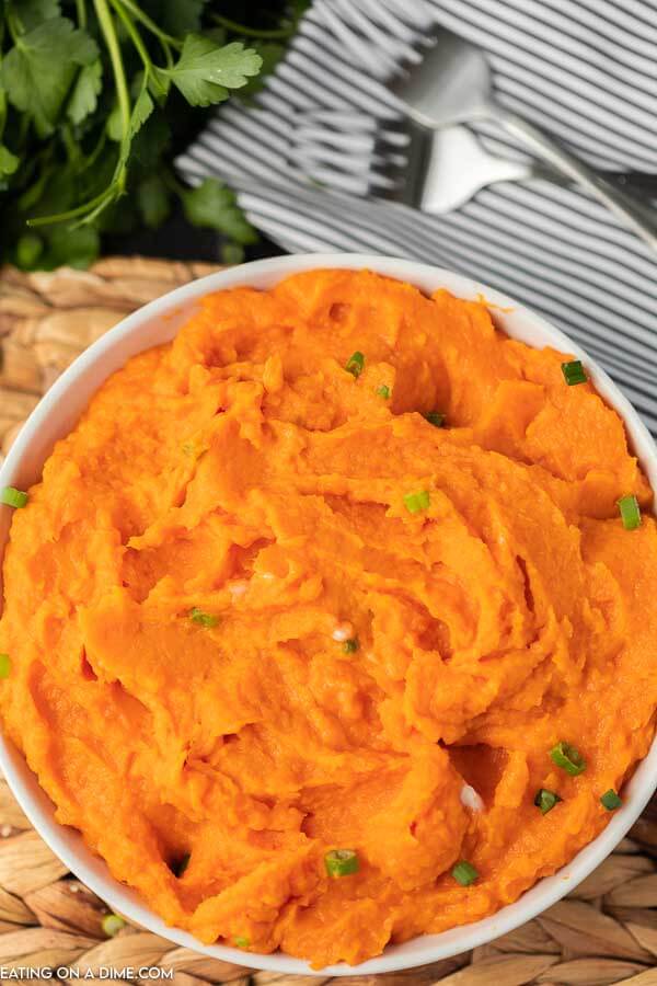 Photo of mashed sweet potatoes in white bowl.