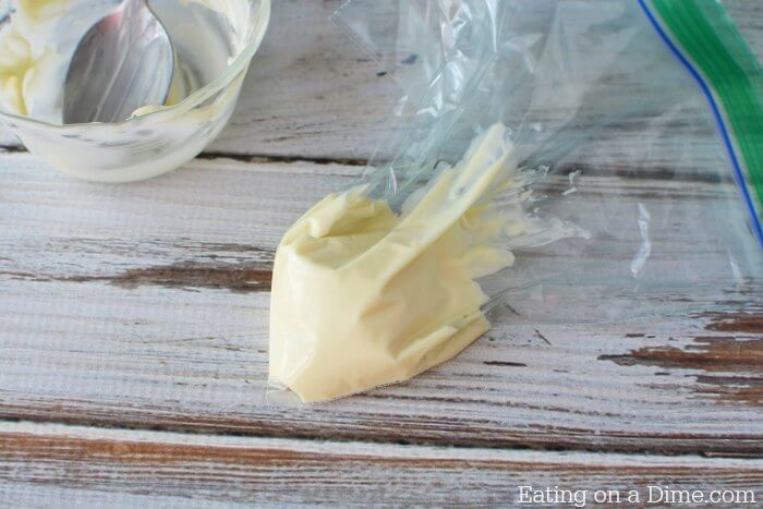 Close up image of the melted white chocolate in a baggie. 