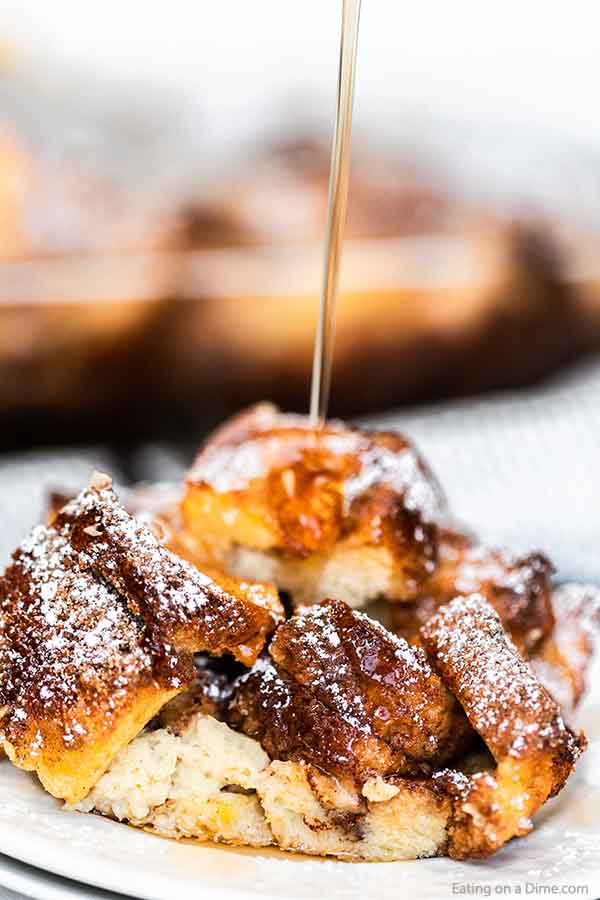 Close up image of french toast casserole with syrup being poured on top. 