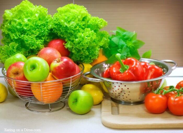 Lots of different fruit and vegetables - apples, oranges, lettuce, peppers and tomatoes 