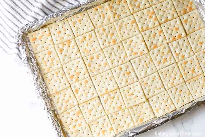 Close up image of crackers on a cookie sheet. 