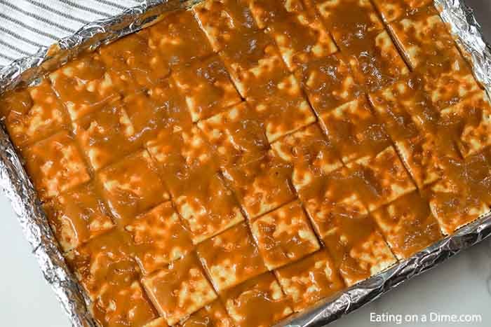 Close up image of saltine cracker toffee in process. 