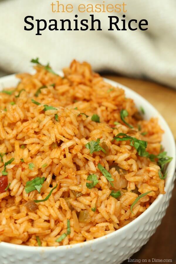 A white bowl full of Spanish Rice topped with fresh cilantro.  