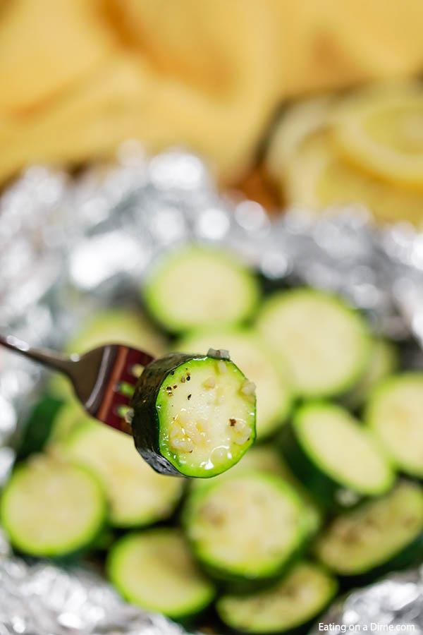 Grilled Zucchini in Foil packets with a bite on a fork