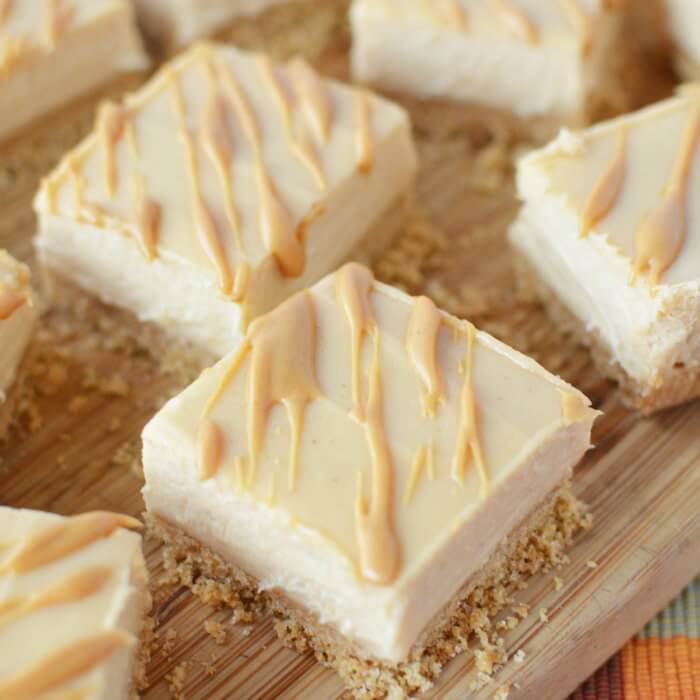 Peanut Butter Cheesecake Recipe will be a hit. Try Easy Peanut Butter Cheesecake Bites Recipe. Mini Peanut Butter Cheesecake bars make the perfect dessert! Everyone will love these easy to make cheesecake bites! #eatingonadime #dessertrecipes #cheesecakerecipes 